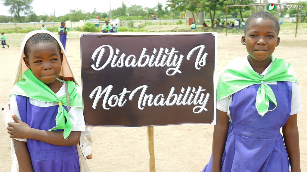 ‘Disability Is Not Inability(장애는 무능력이 아니다.)’ 팻말 옆 케냐 아동들.jpg