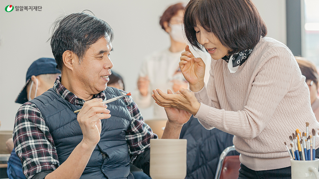 도자기 그릇에 그림을 그리고 있는 시청각장애인과 활동지원사(2).jpg